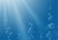 Underwater air bubbles on  blue background. Water background with sunlight and vertical streams of air bubbles. Royalty Free Stock Photo